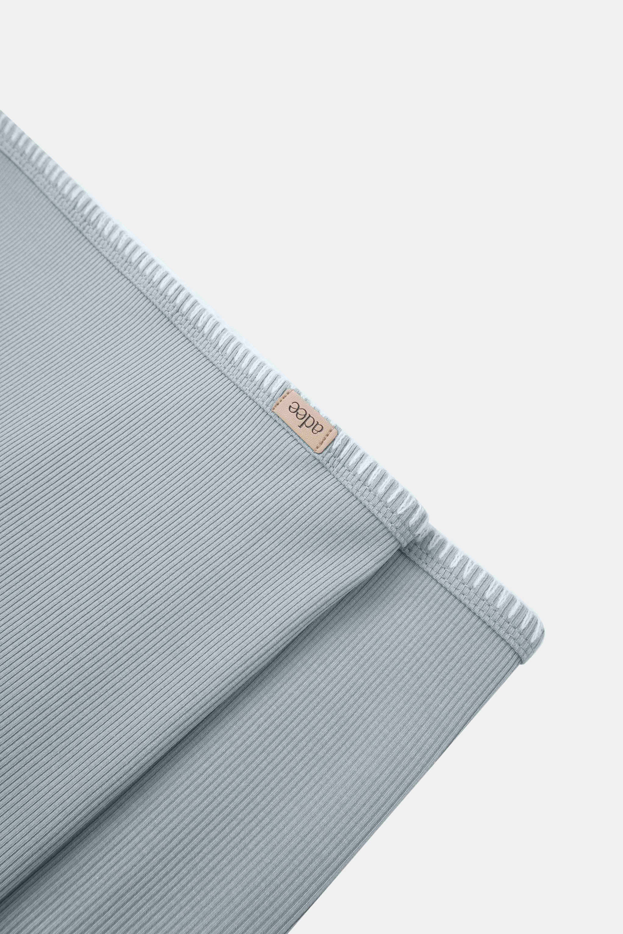 Legacy Stitch Blanket Light Blue swaddle by Adee for boys; ribbed fabric with beige brand tag