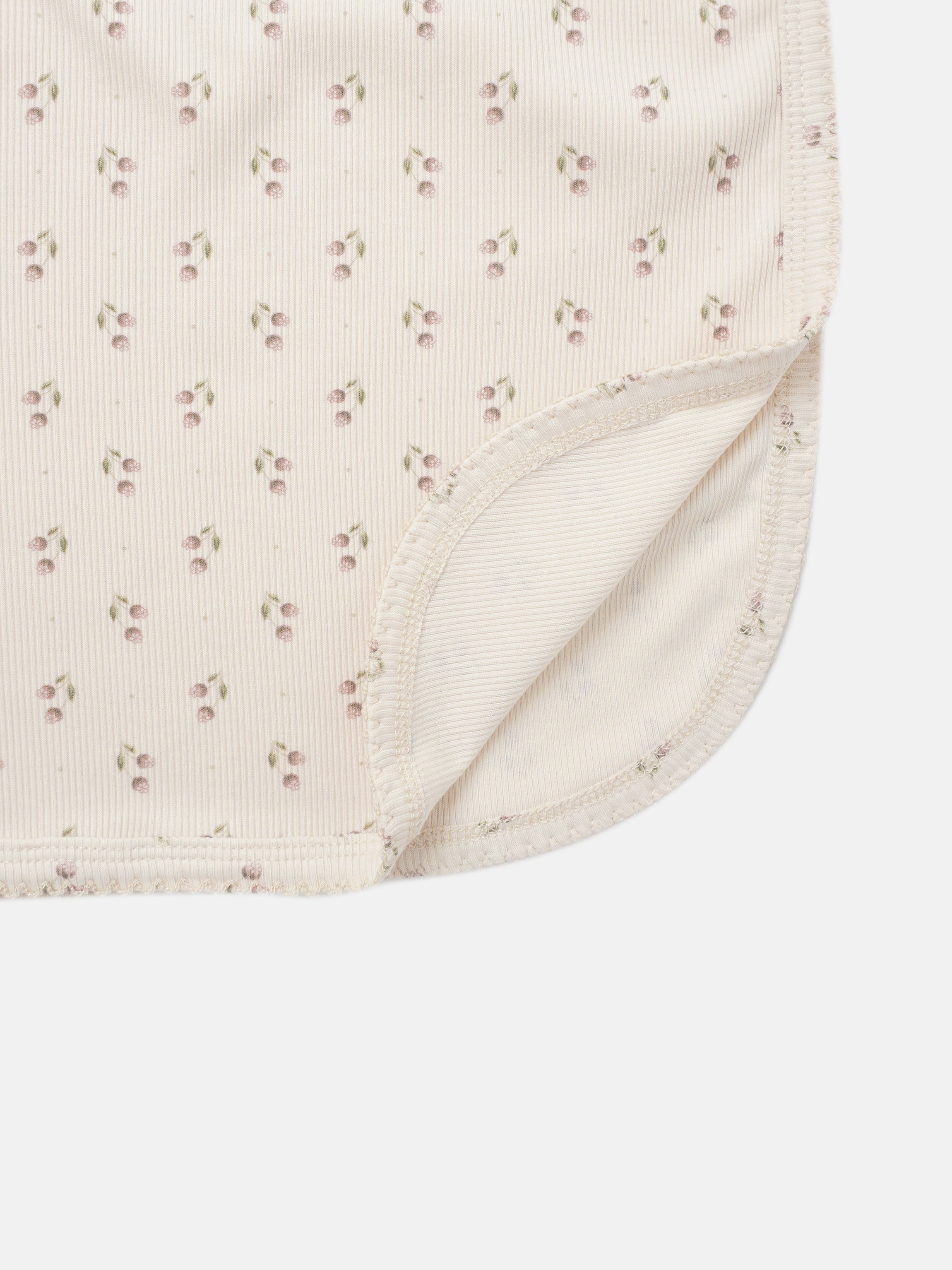 Tiny Tulip Blanket swaddle for girls with pale pink cherry print and ribbed edge