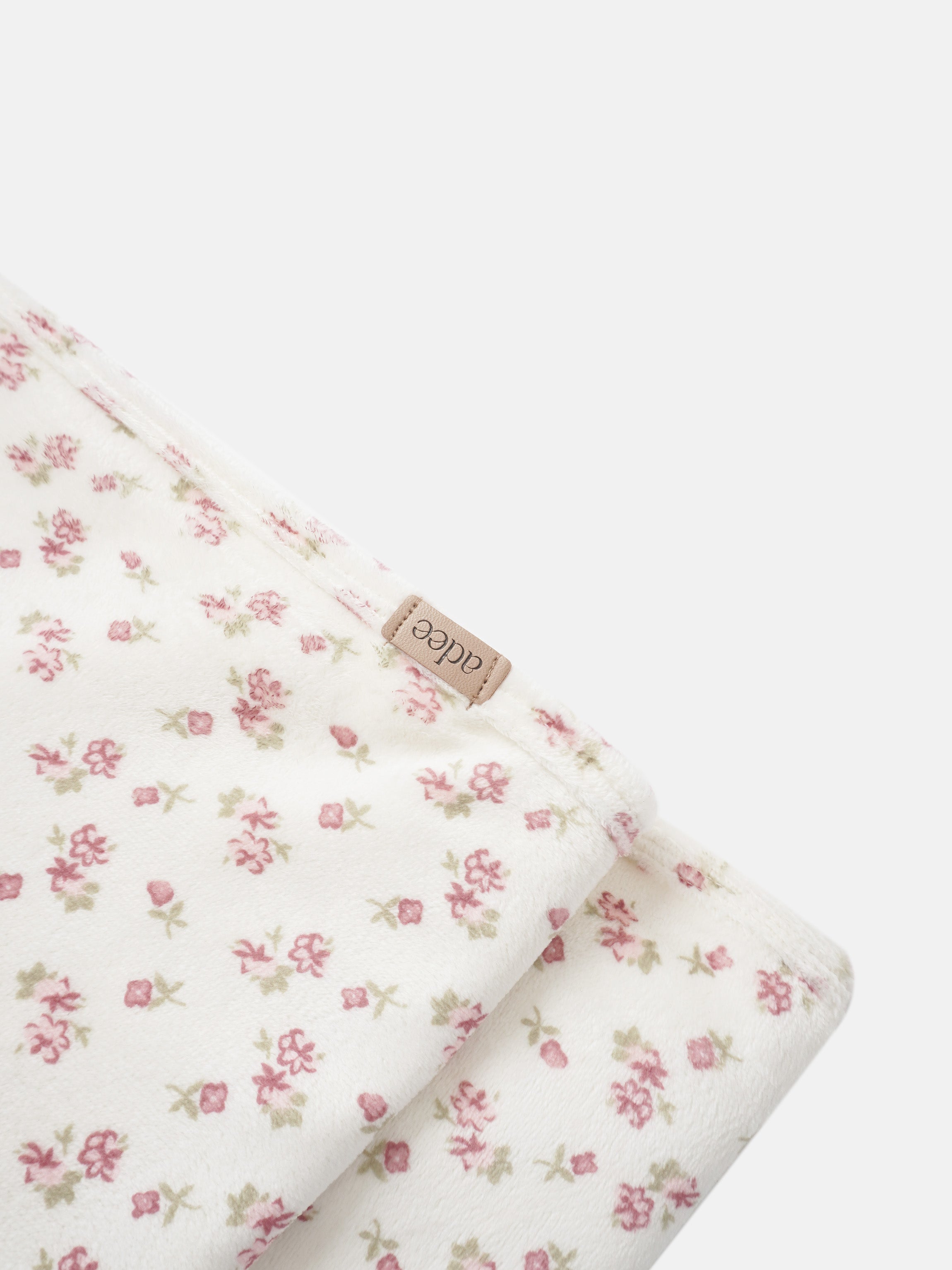 Tiny Blossom Blanket swaddle by Adee, white fabric with pink floral print.