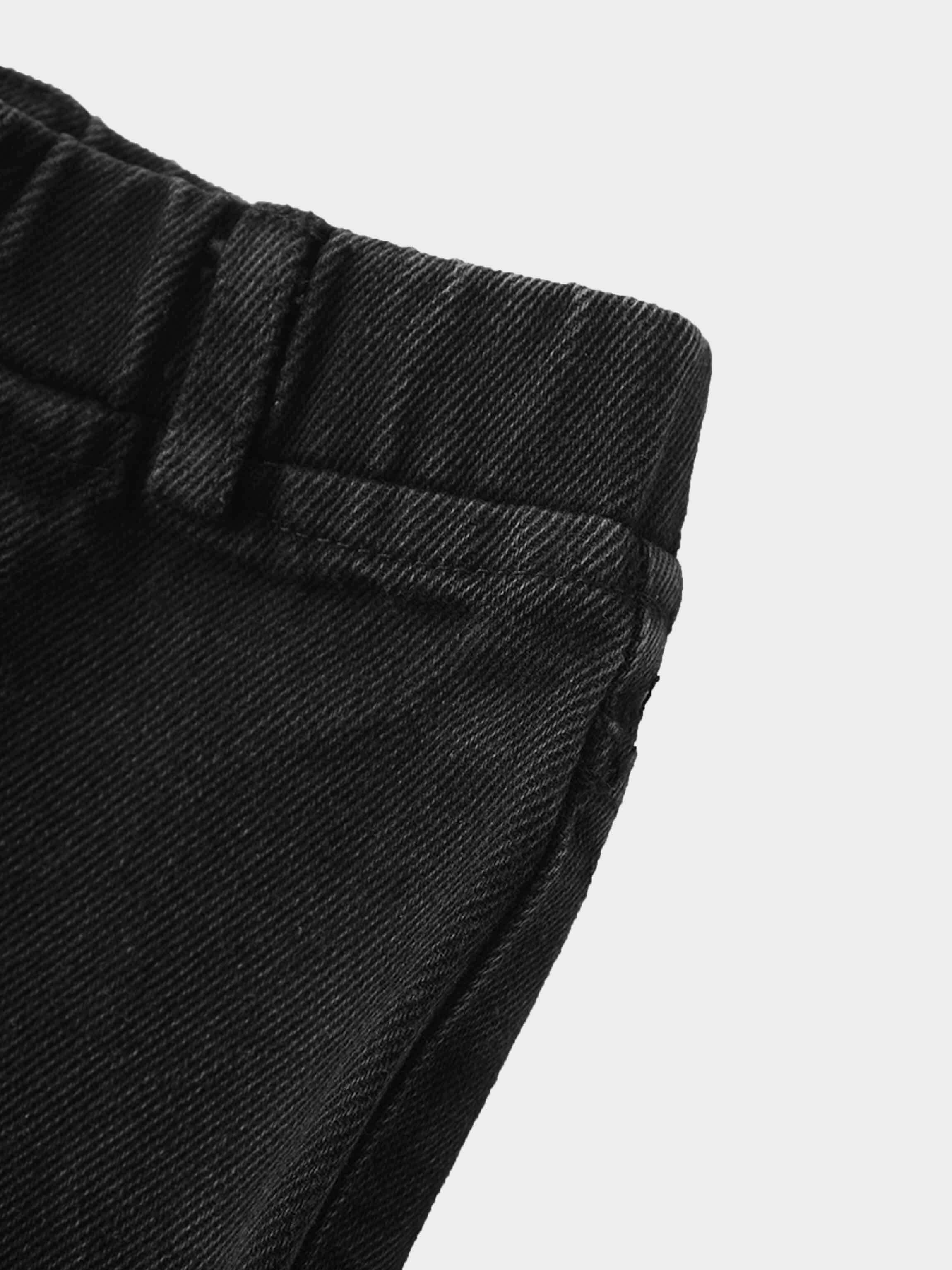 Black denim shorts waistband close-up