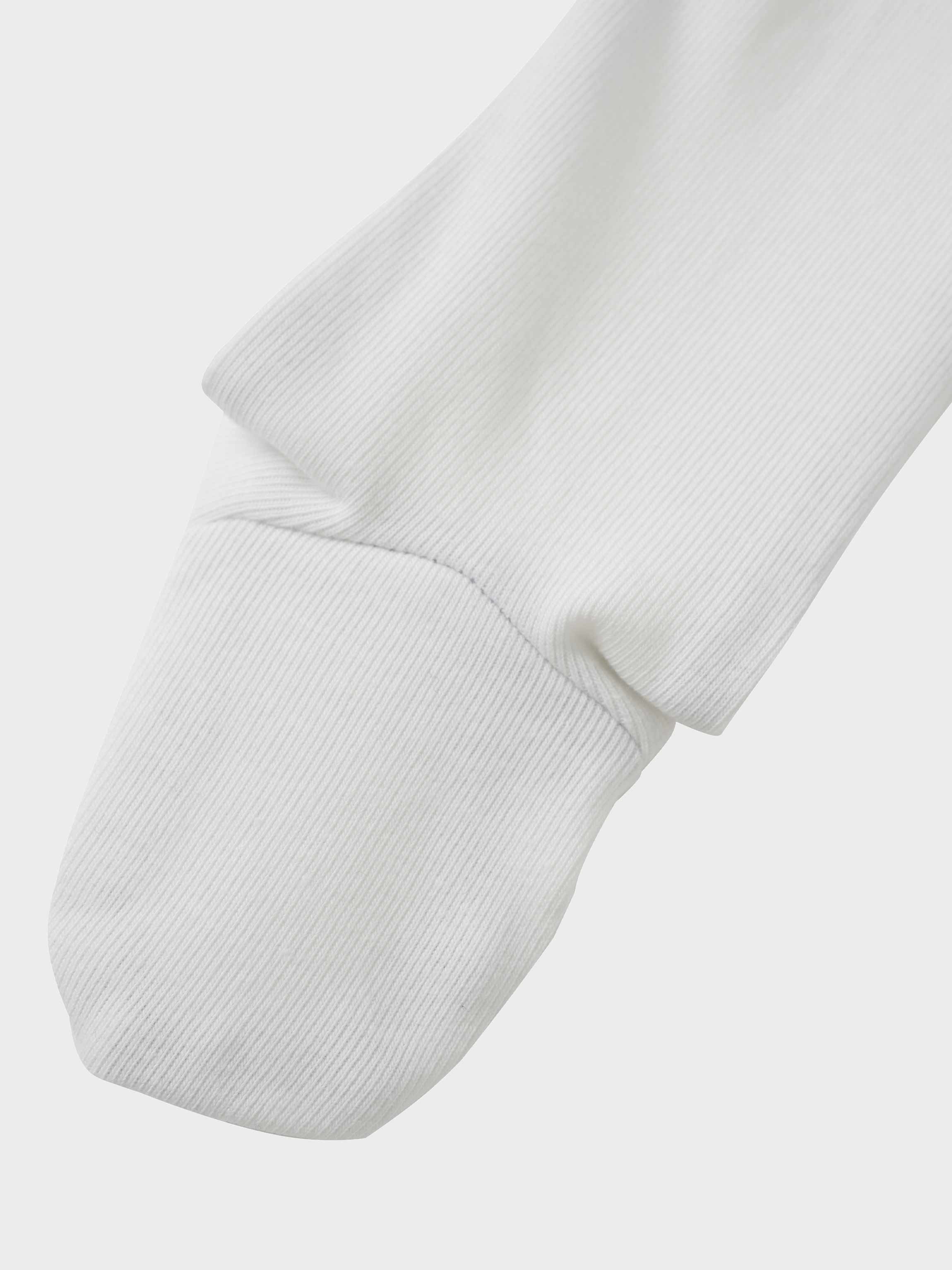 Mini Gallery Stretchy boys jumpsuit sleeve in white ribbed knit fabric.