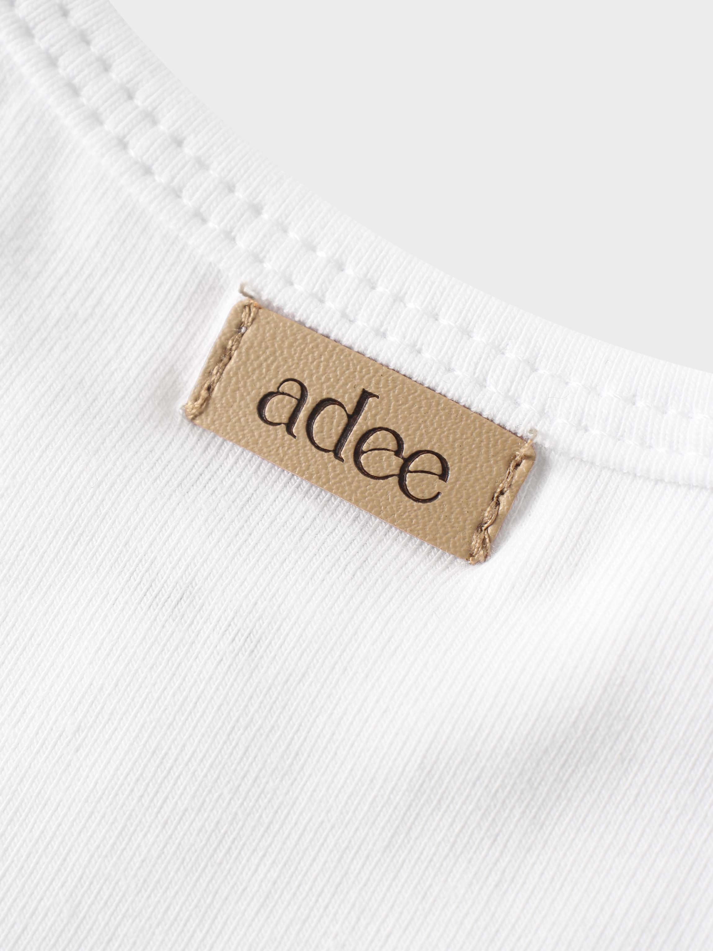 adee label on white shirt