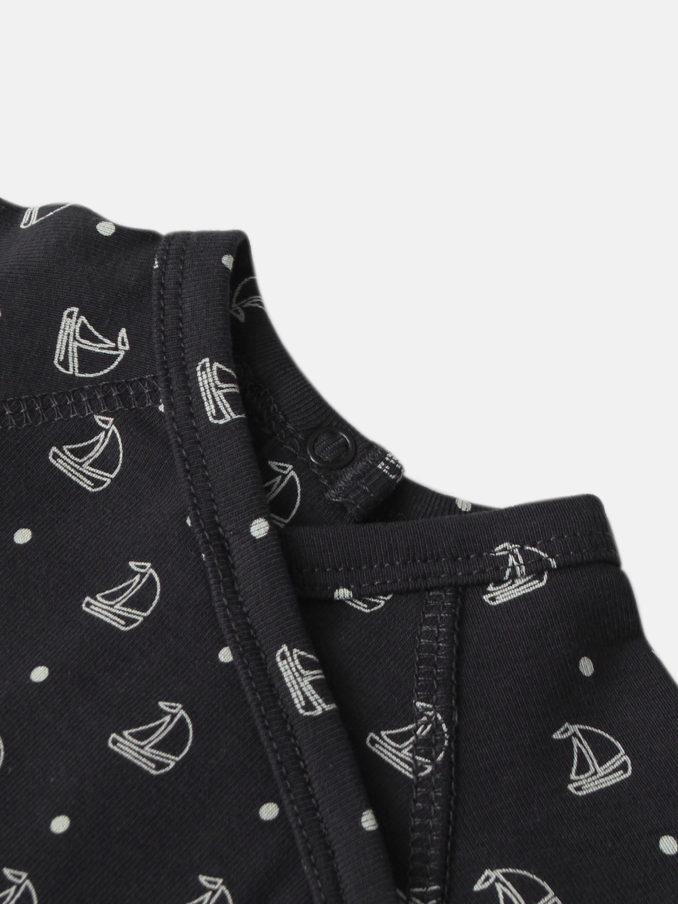 Harbor Dot layette set for boys; navy fabric with white sailboats and polka-dot pattern, close-up stitching.
