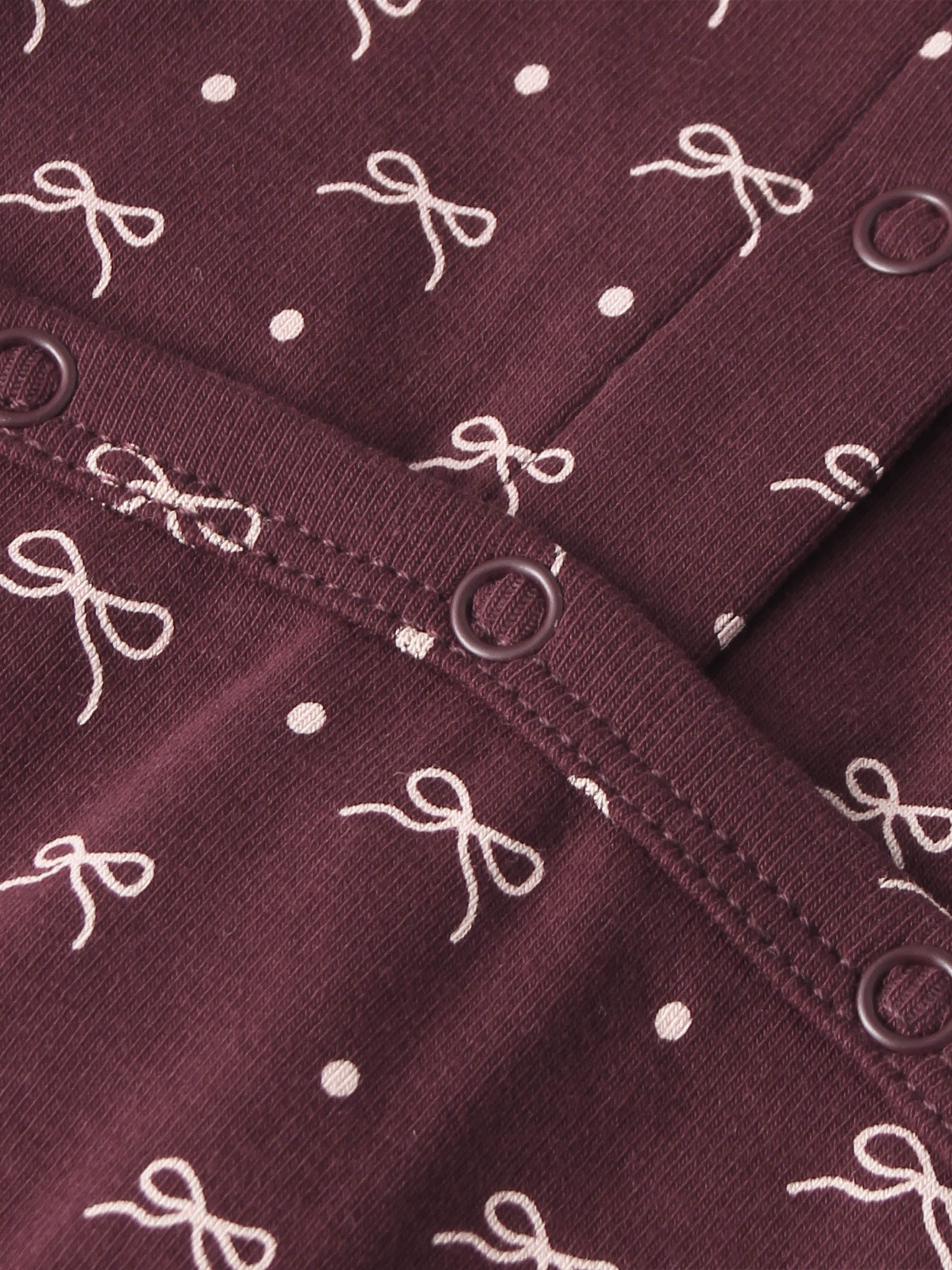 Burgundy Bow Stretchy fabric for girls by Adee with white bow pattern and metal eyelets