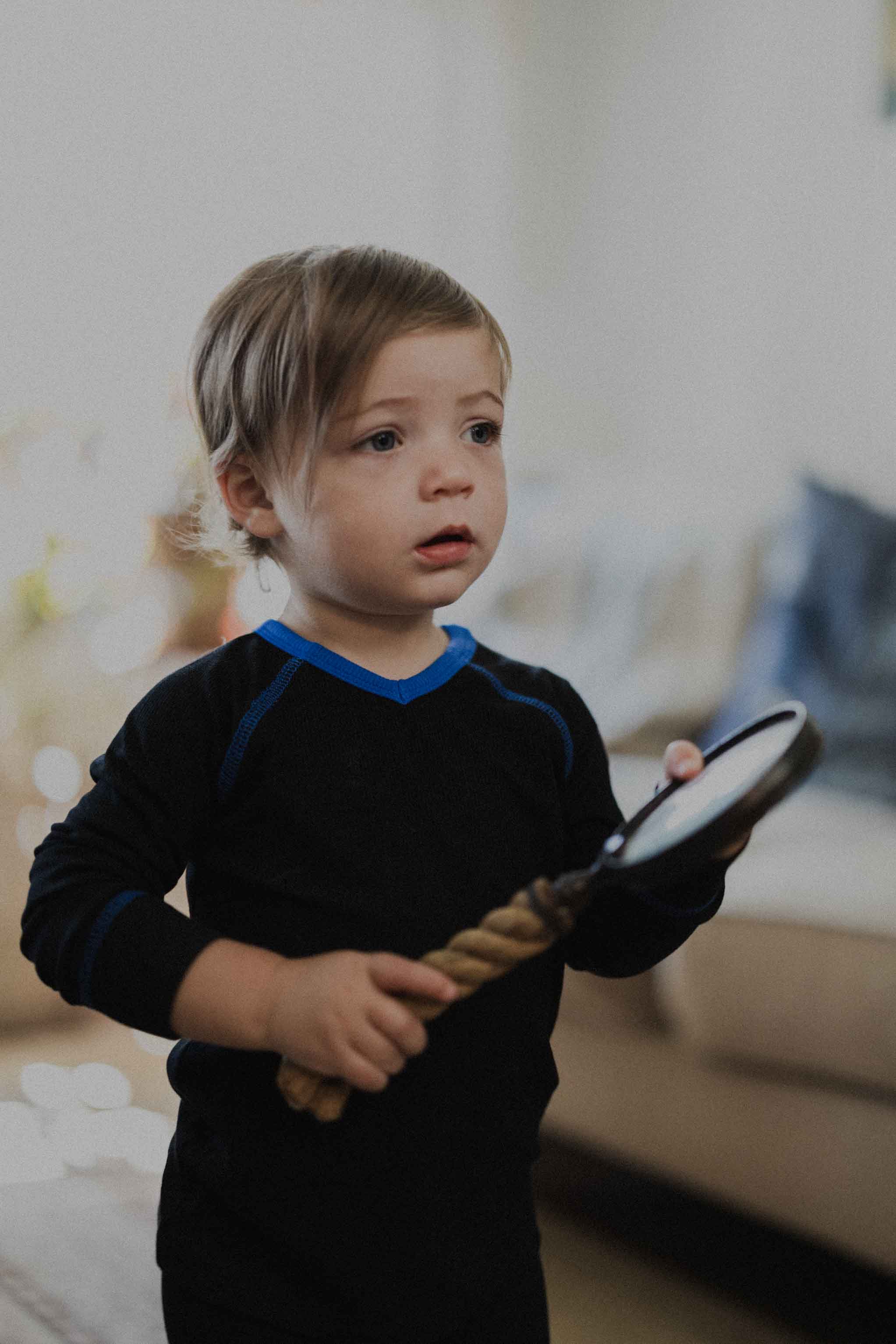 Boy wearing blue stitched pajamas.