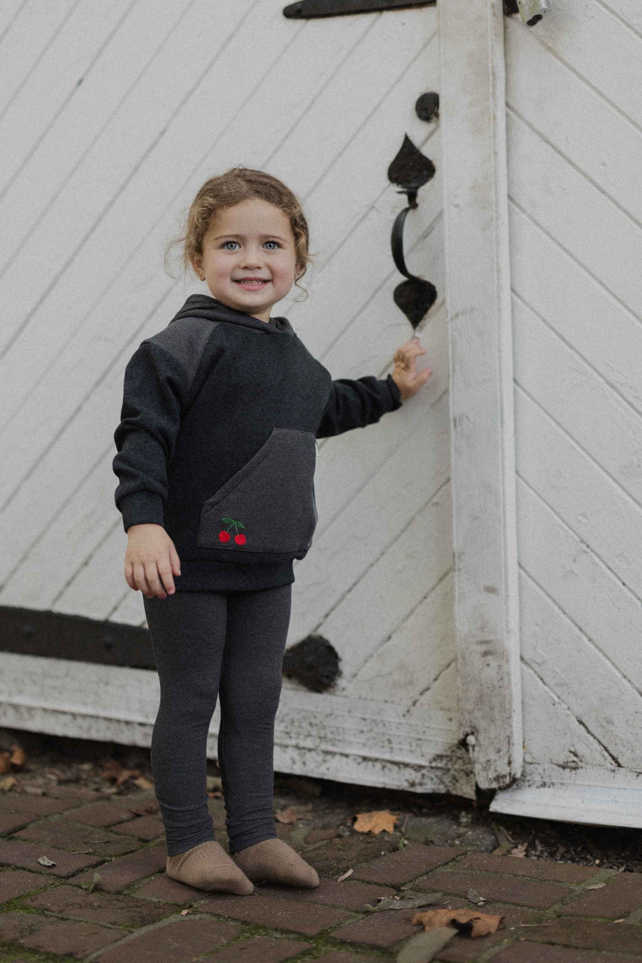 Girl in hoodie with leggings.