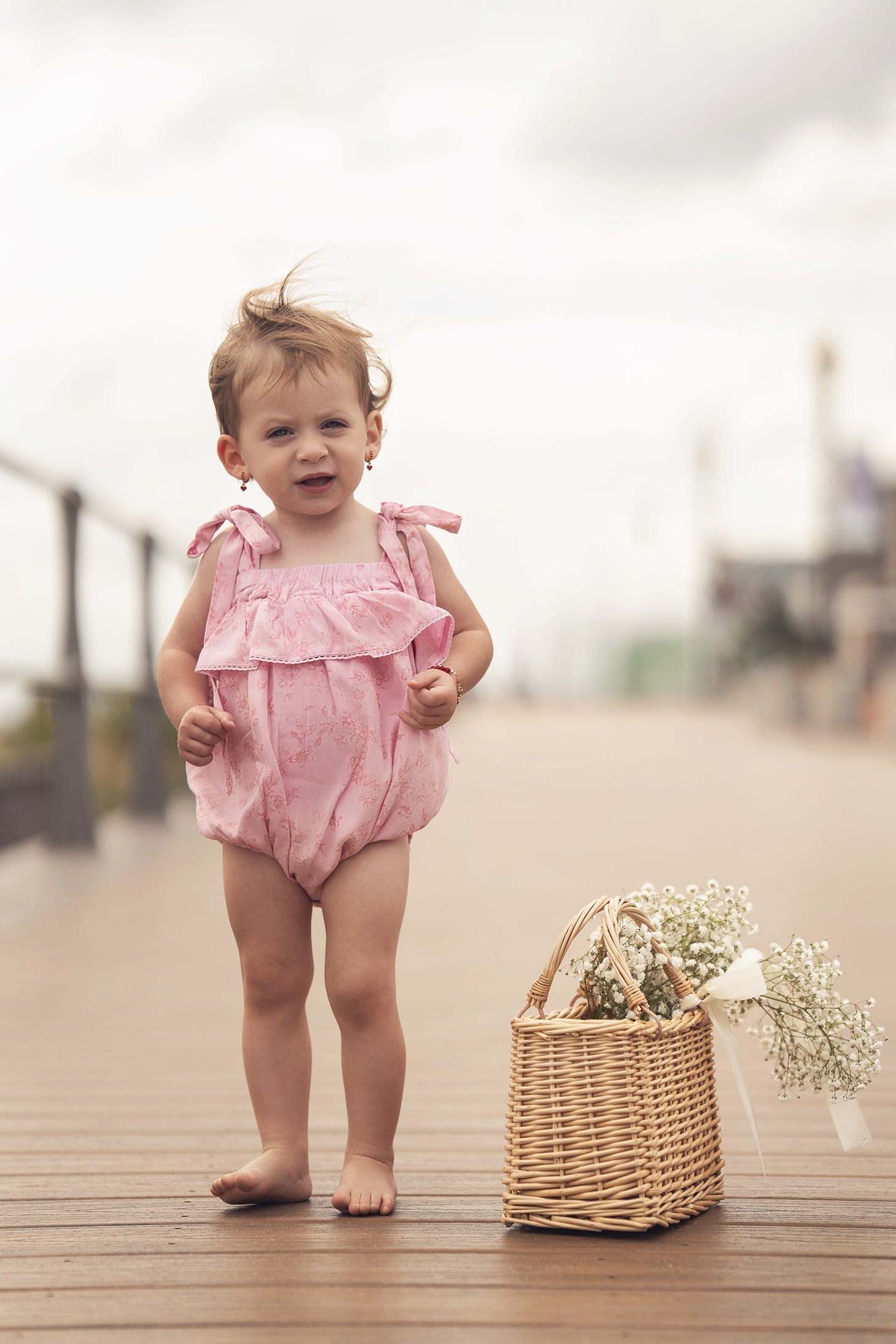 Pink Flower Romper for girls by Adee; dressy pink floral romper with tied shoulders and a ruffled top.