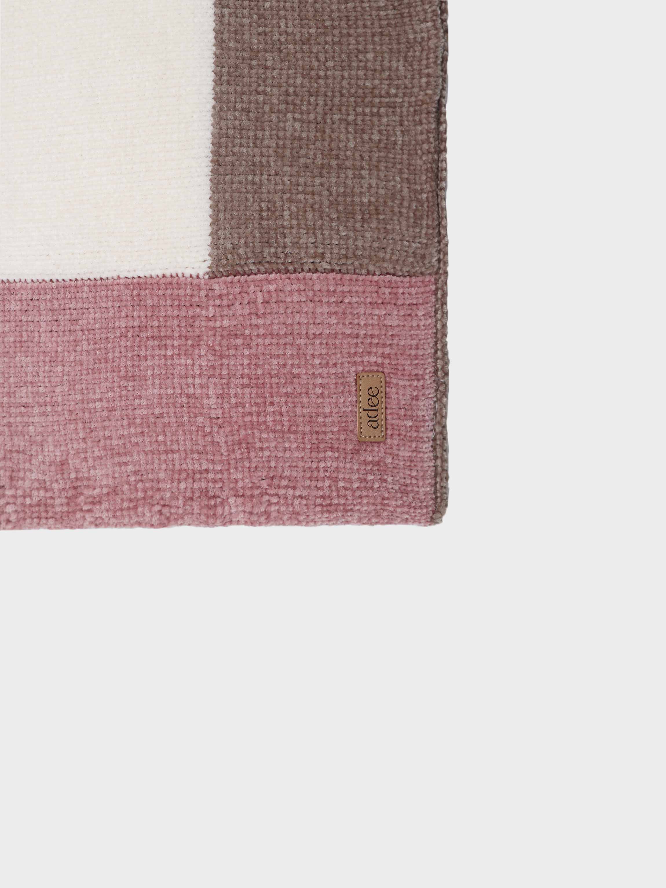 Butter soft pink crocheted baby blanket with off-white center and brown accents