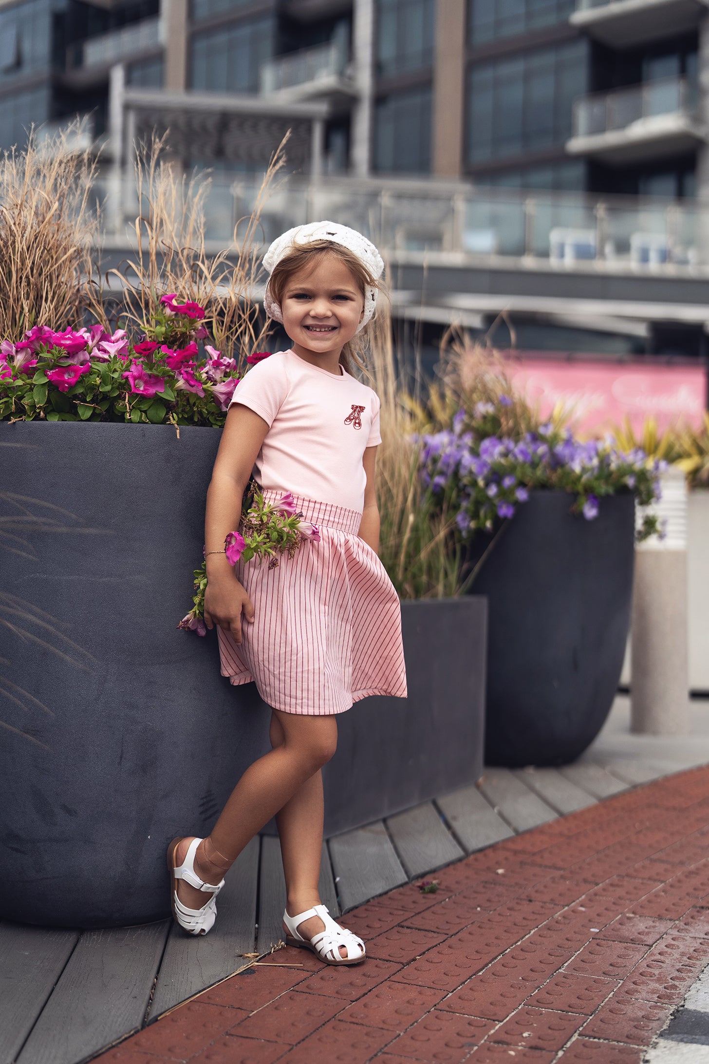 Short Sleeve Emblem T-shirt in light pink by Adee; girls top shown with pink striped skirt