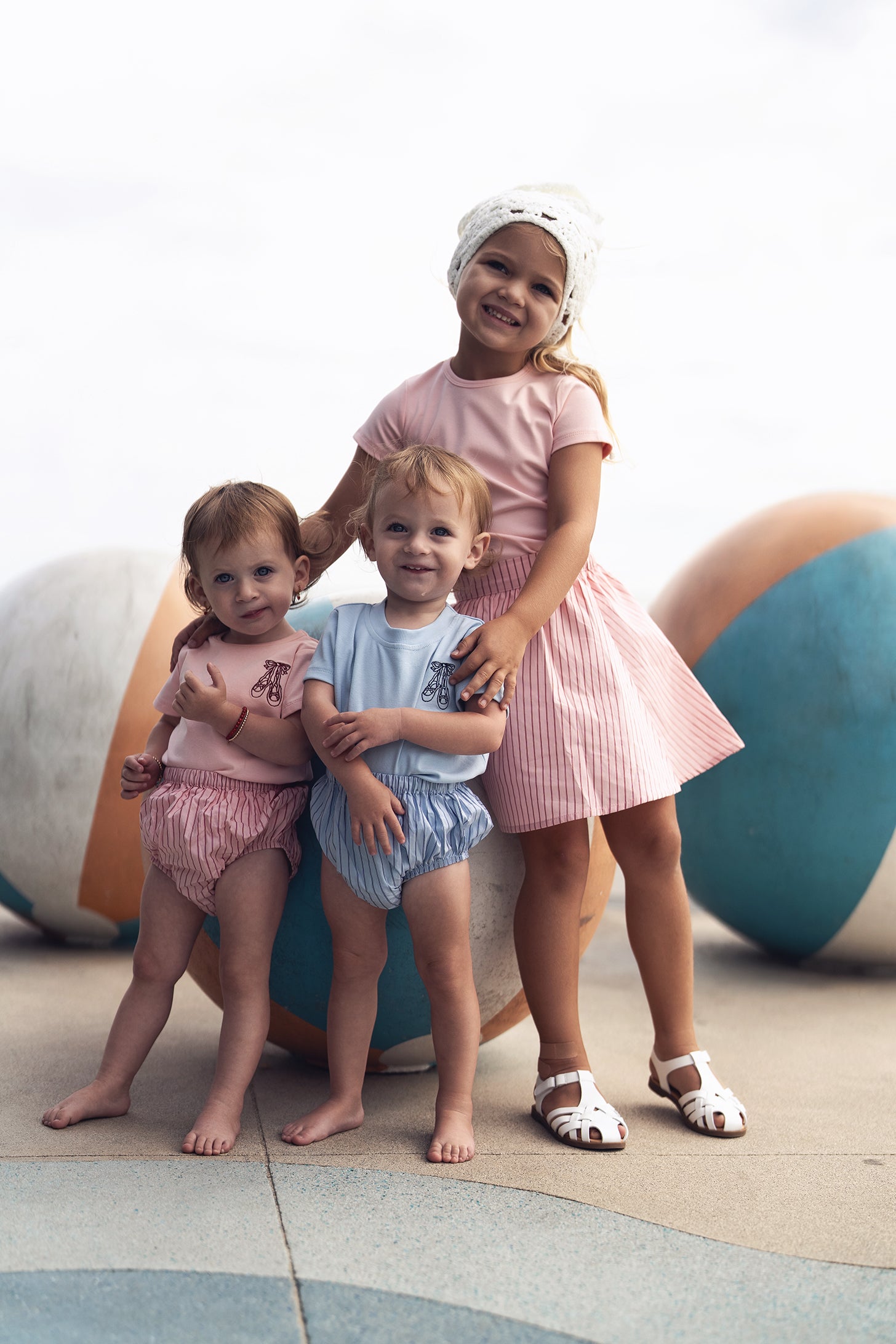 Striped pink cotton skirt for girls by Adee, worn by a smiling girl.
