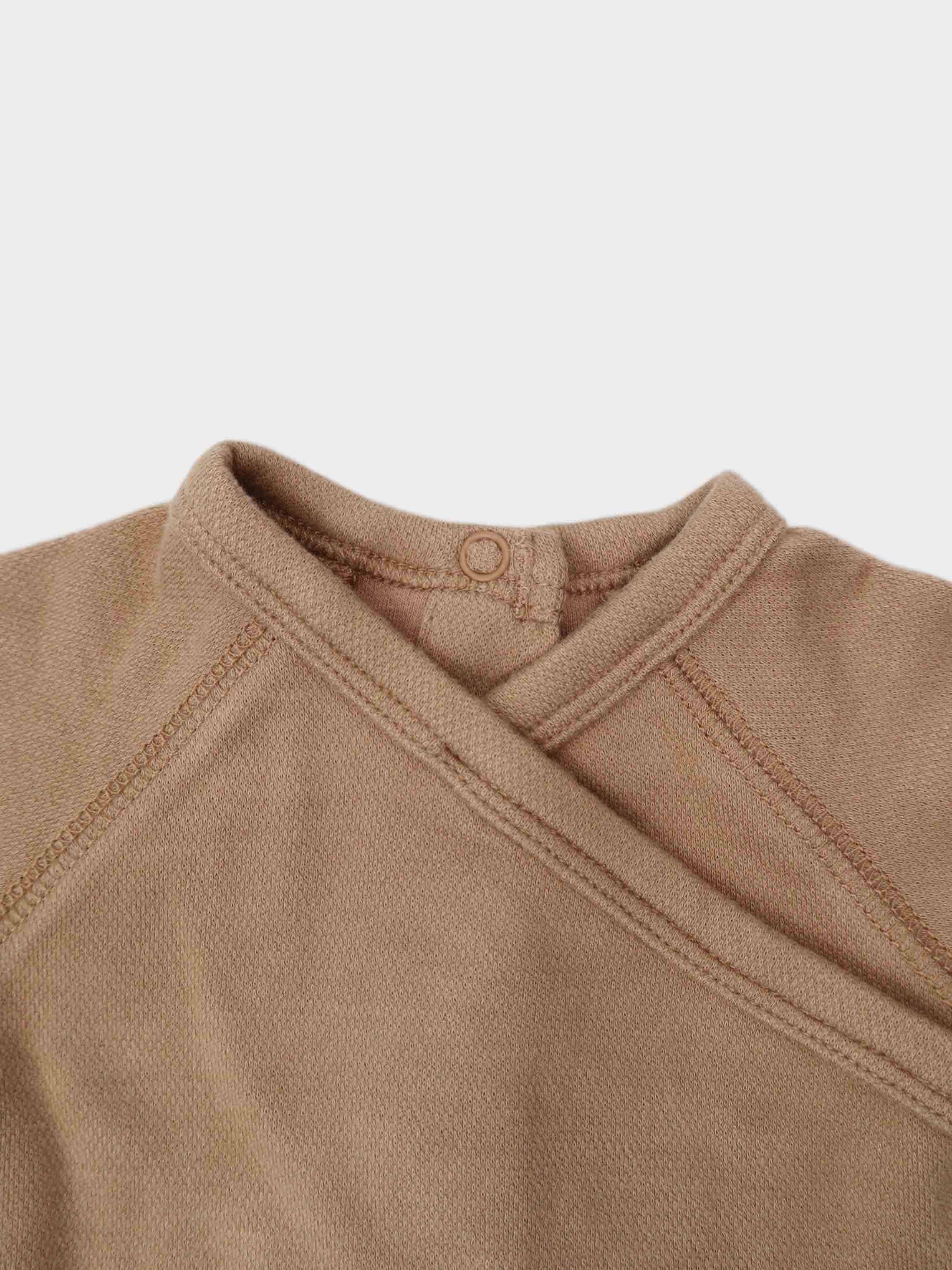 Unisex Stretchies crossover top in bonnet-taupe by Adee; close-up of knit neckline with snap detail.