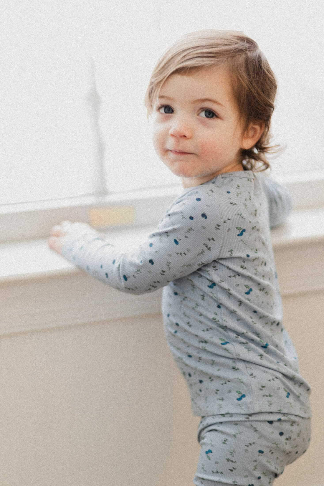 Child in blue berry pajamas
