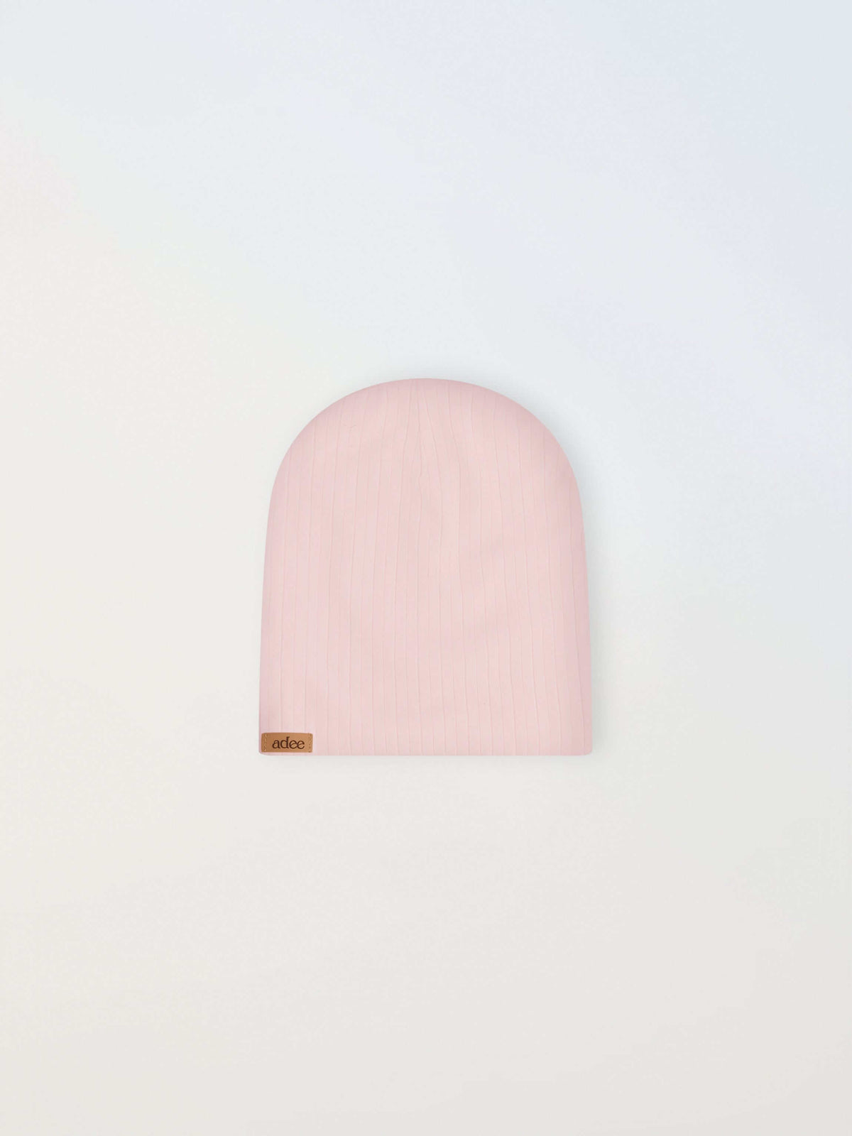Wide ribbed girls beanie in light pink by Adee, with a small brown tag.