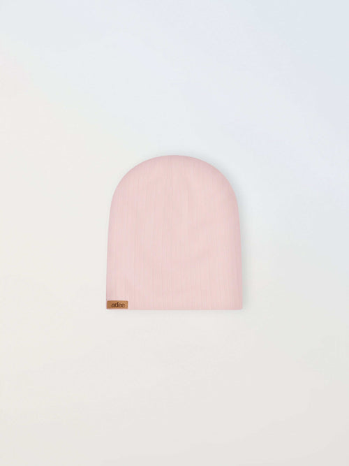 Wide ribbed girls beanie in light pink by Adee, with a small brown tag.