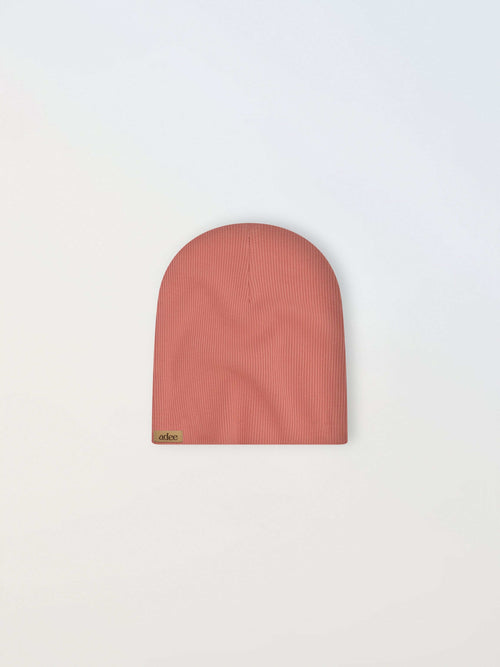 Thin ribbed pink girls beanie by Adee with a small beige tag.