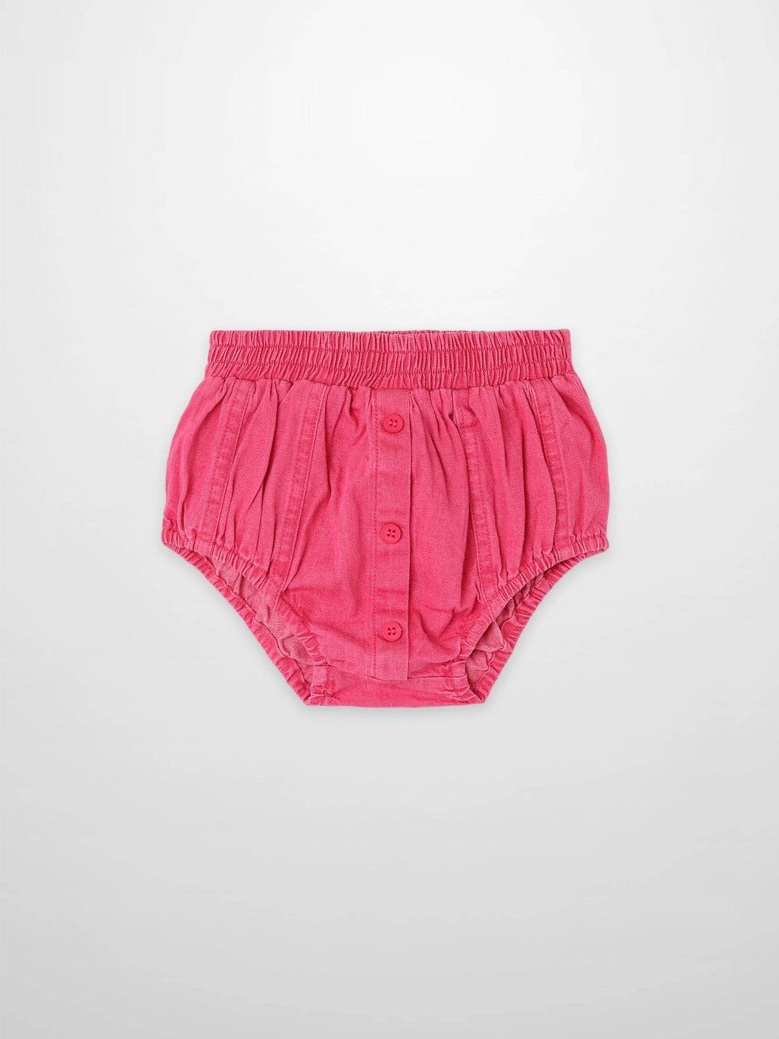 Paneled pink denim bloomers for babies with elastic waist and front button placket.
