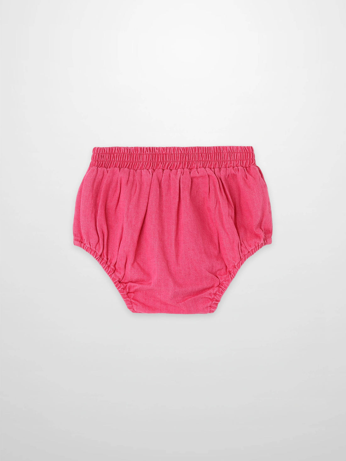 Paneled Bloomers in pink denim with elastic waistband and gathered leg openings.