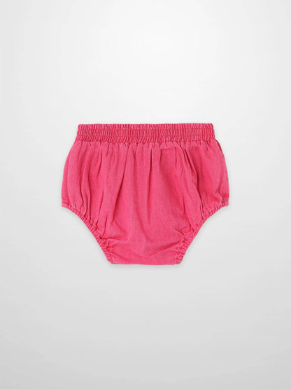 Paneled Bloomers in pink denim with elastic waistband and gathered leg openings.