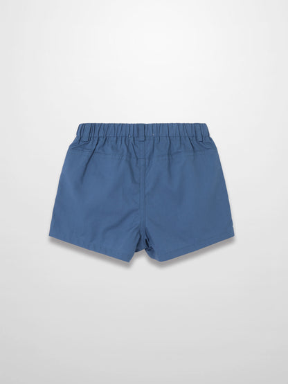 Back view of blue cotton shorts with elastic waistband and stitch details.