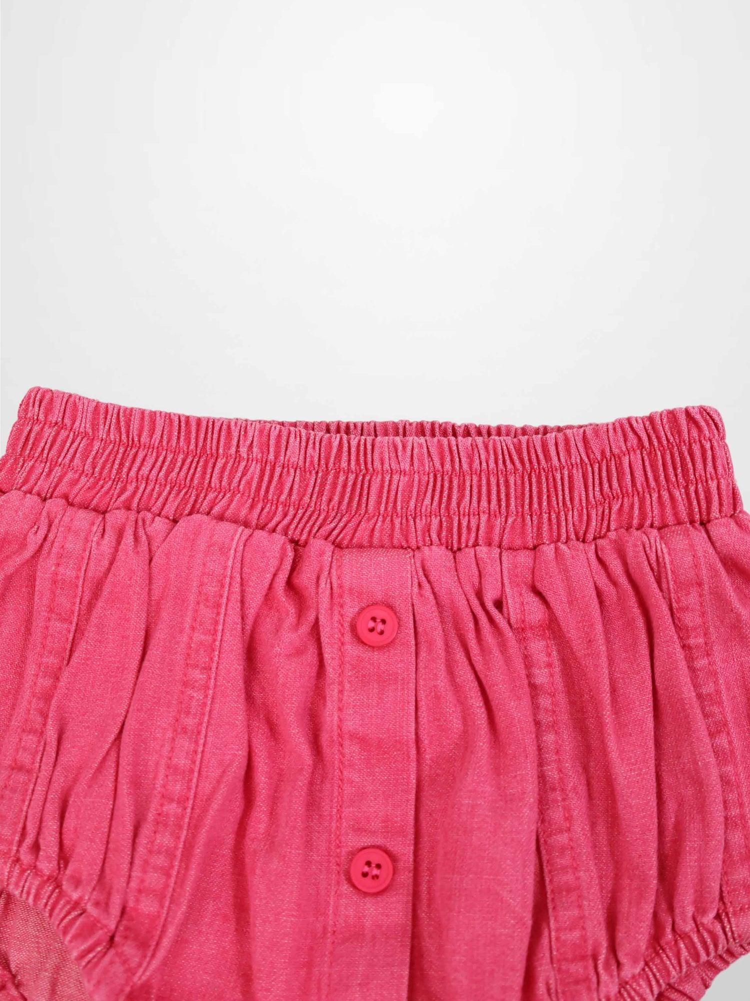 Pink denim paneled bloomers with elastic waistband and front pink buttons.