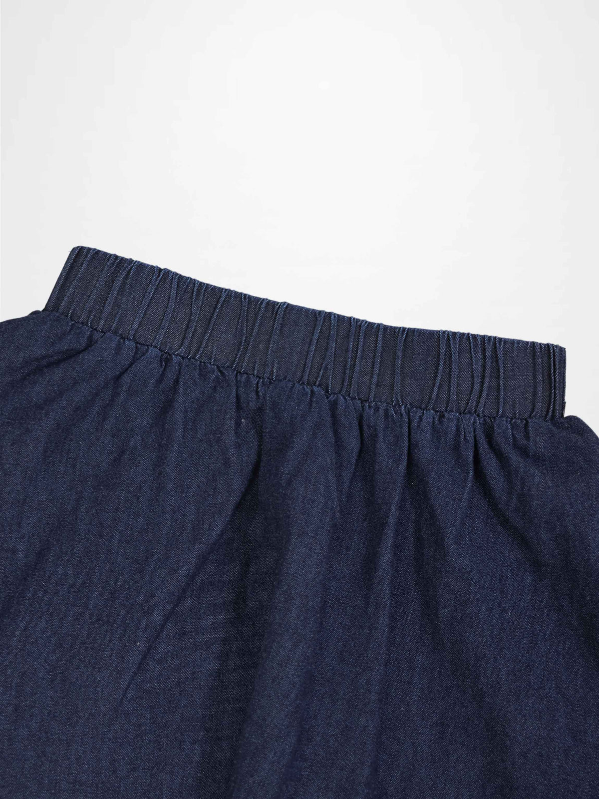 Circle skirt for girls in dark denim with an elastic waistband; thin fabric.