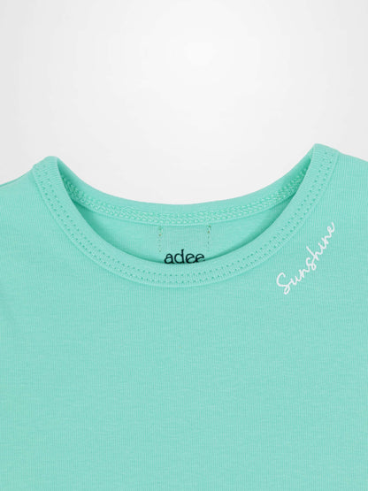 Mint green 3/4 puff sleeve T-shirt close-up of neckline with visible stitching and &
