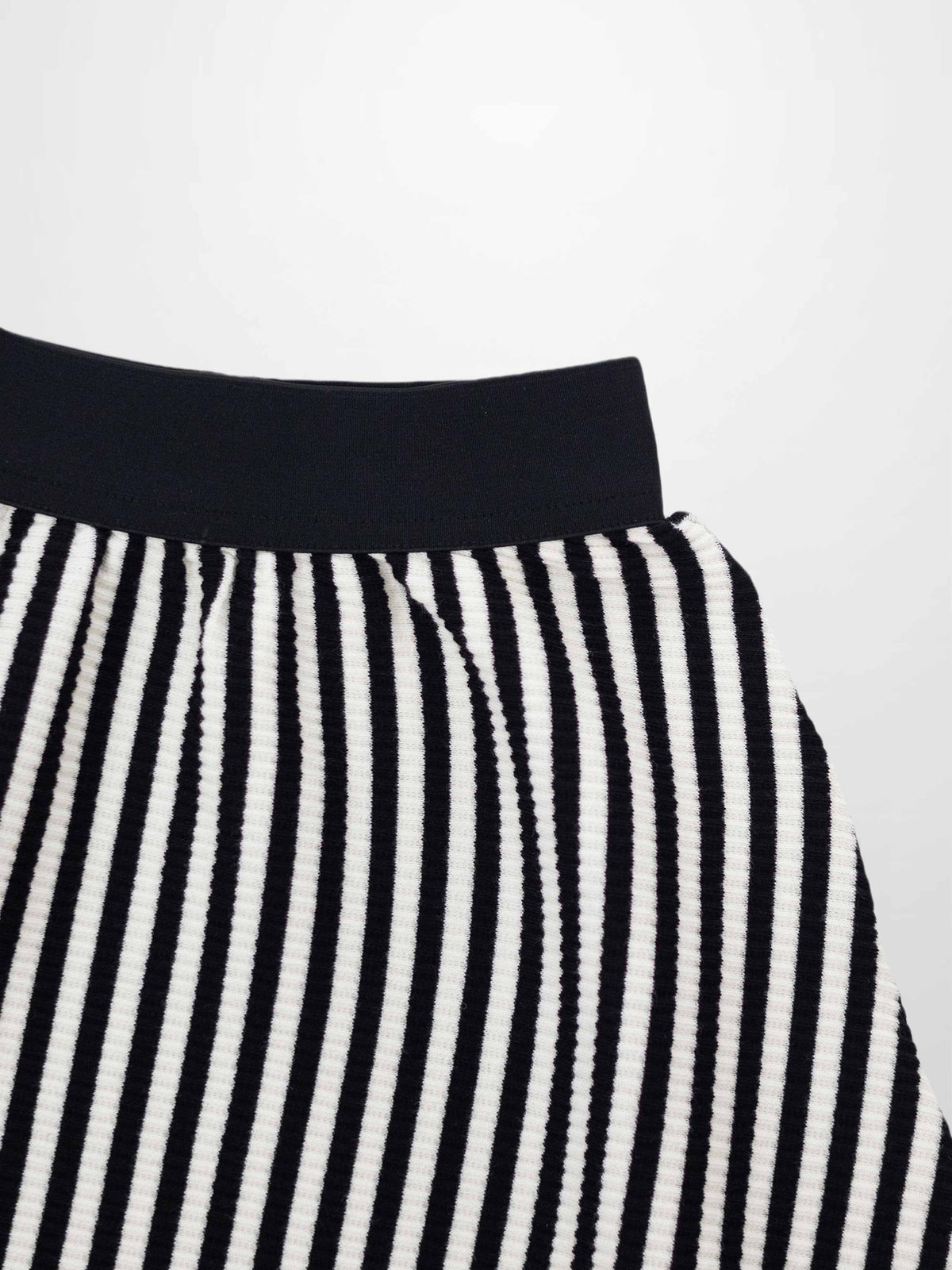 Striped circle skirt for girls with black elastic waistband and textured ribbed fabric.