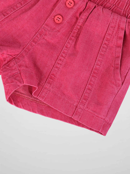 Pink denim paneled shorts with elastic waist and button-front closure.