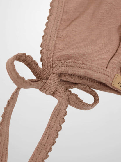Girls pink scalloped bonnet by Adee in dusty pink knitted fabric with tie straps