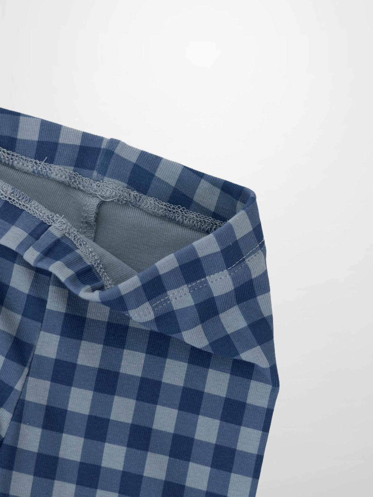 Gingham Pajamas - Blue fabric close-up showing blue checkered pattern and elastic waistband.