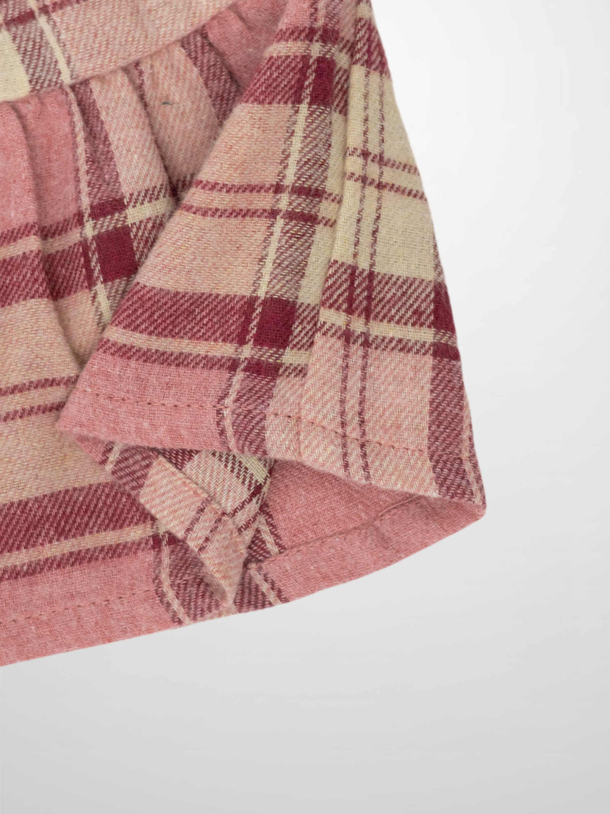 Girls plaid skirt in pink and deep red tones, dressy style, woven fabric with folded hem
