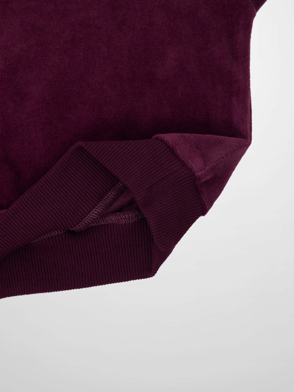 Velour Logo Set by Adee in burgundy; close-up of ribbed cuff on velour sweatshirt.