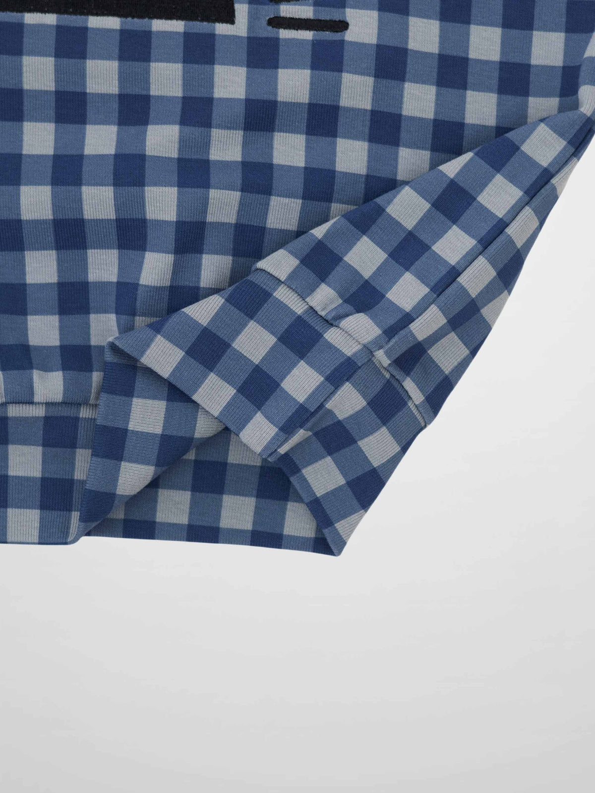 Blue gingham pajama top with long sleeves and cuff detail.