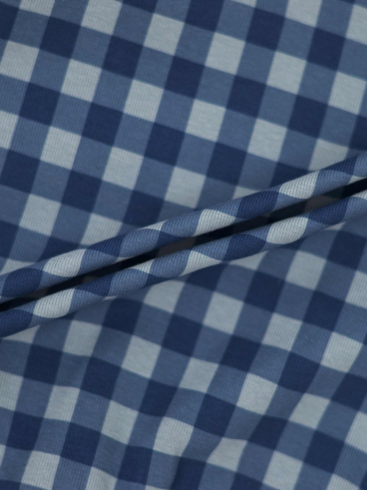 Gingham Pajamas - Blue fabric close-up with folded edges.