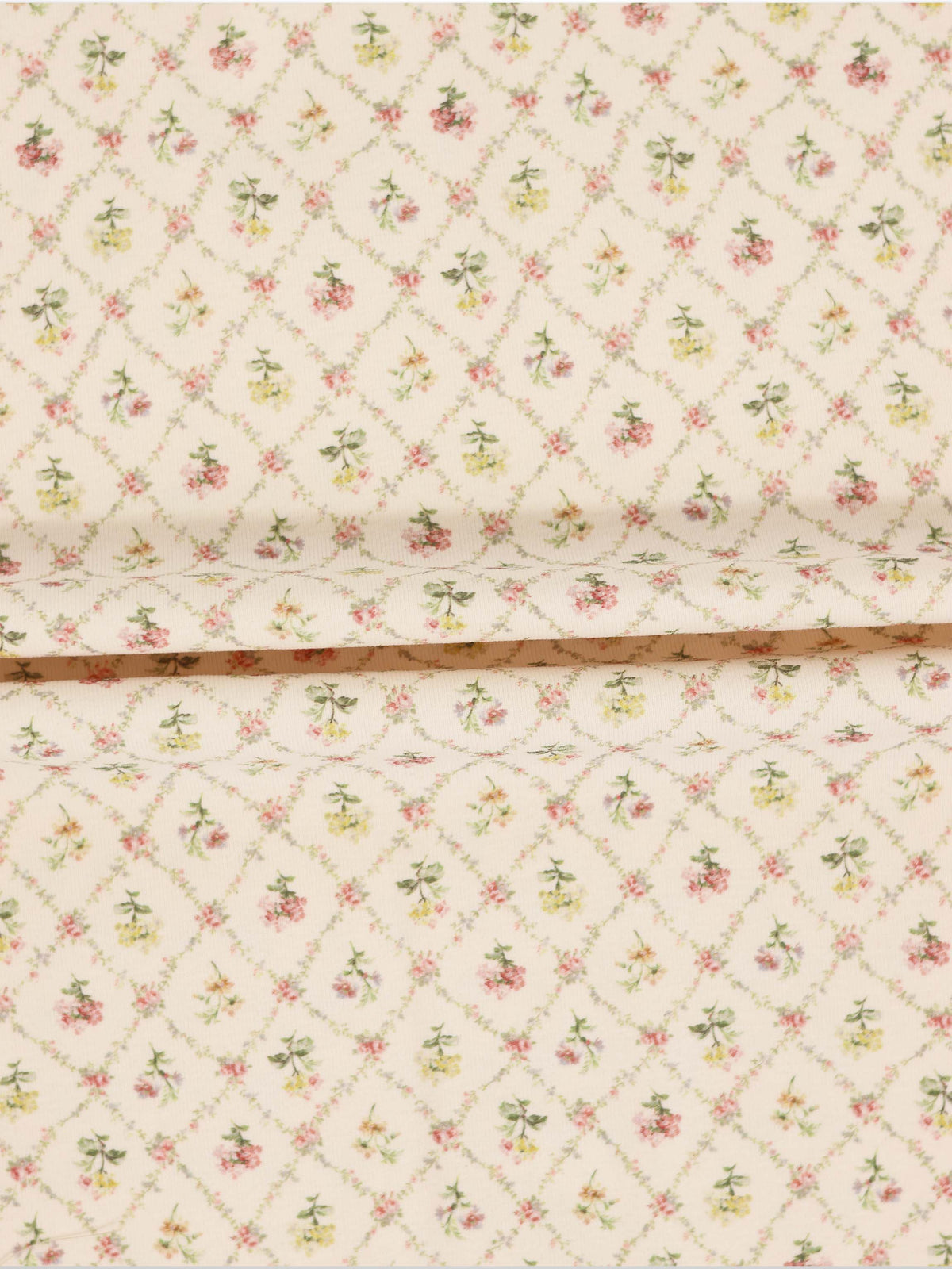 Flower Garden Stretchy girls stretchies fabric with a lattice-diamond floral pattern in pink, yellow and green on beige