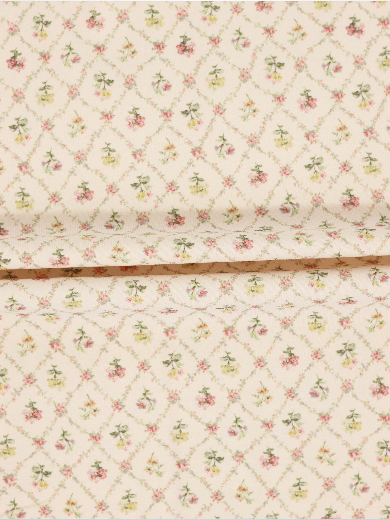 Flower Garden Stretchy girls stretchies fabric with a lattice-diamond floral pattern in pink, yellow and green on beige