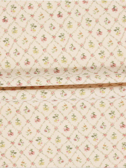 Flower Garden Stretchy girls stretchies fabric with a lattice-diamond floral pattern in pink, yellow and green on beige