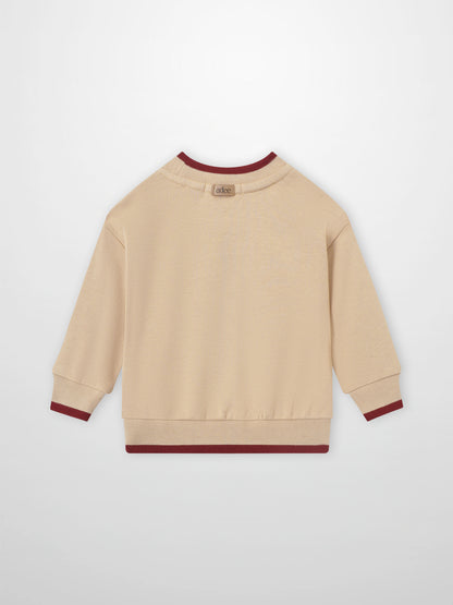 Embroidered Tulip Sweatshirt, girls tops by Adee, beige knit with maroon cuffs and hem.