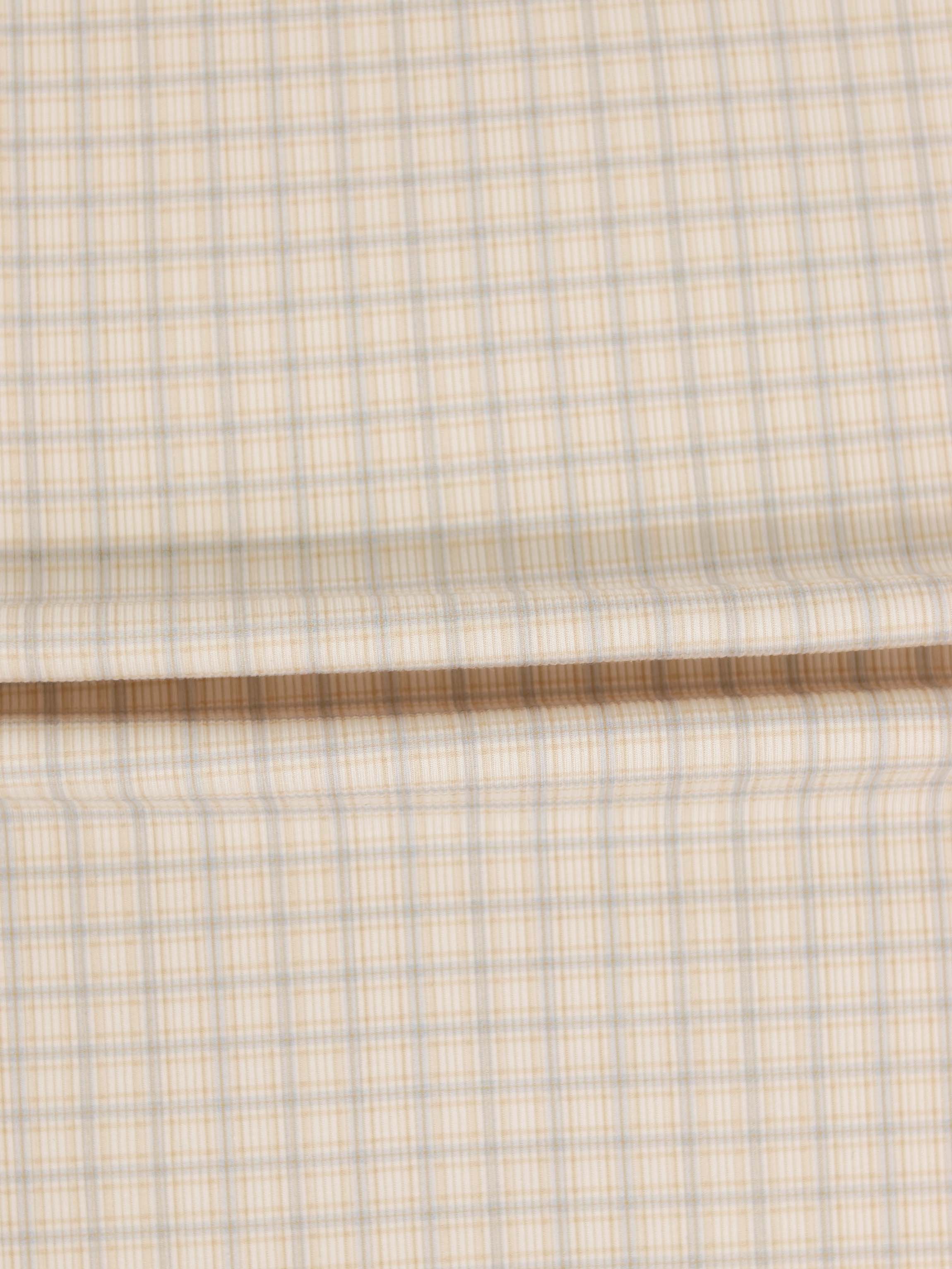 Oatmeal Grid Stretchy fabric swatch in beige with blue grid lines.
