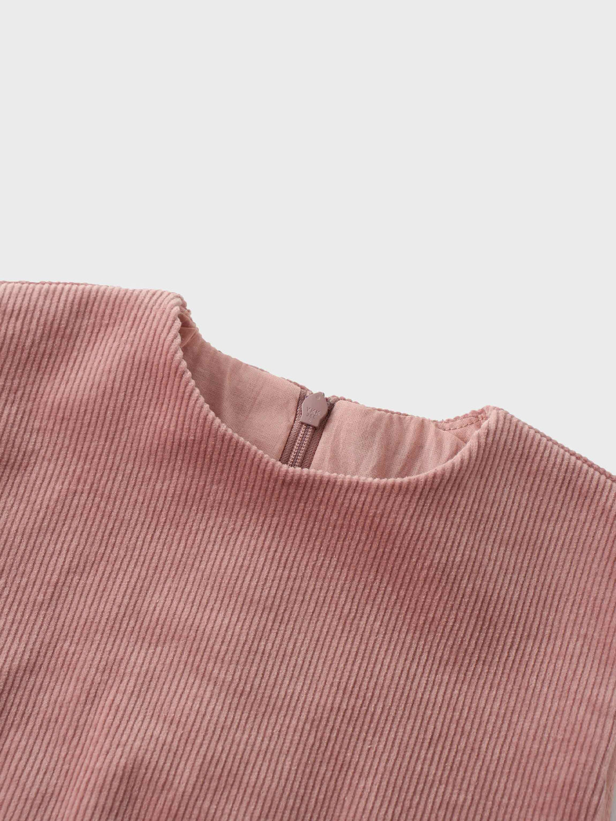 Mauve corduroy jumper neckline with back zipper, showing soft ribbed texture.