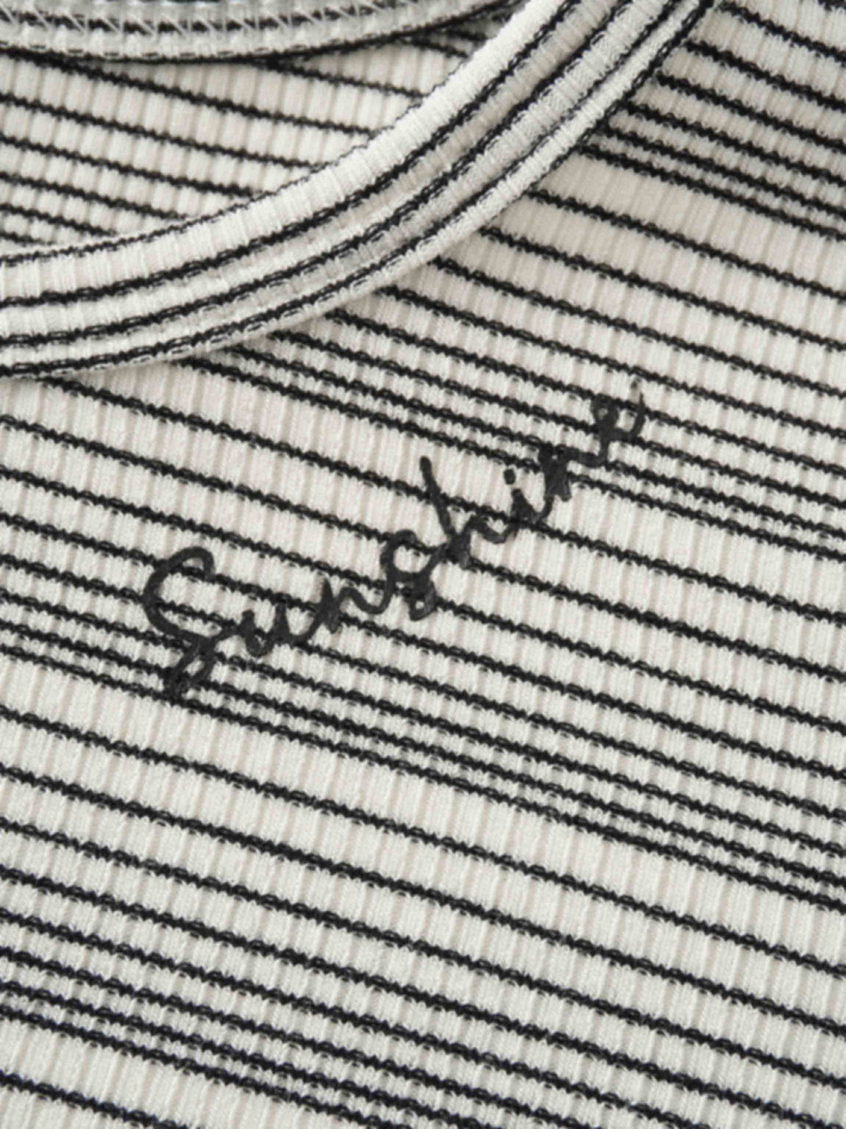Textured white knit with thin black stripes and a black &