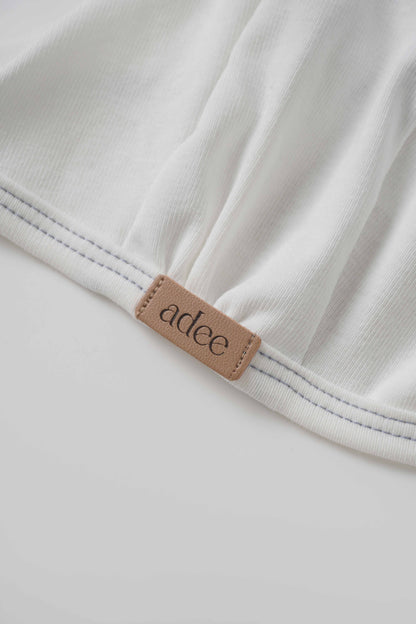 Mini Gallery Bonnet for boys by Adee; white fabric with blue stitching and tan logo patch