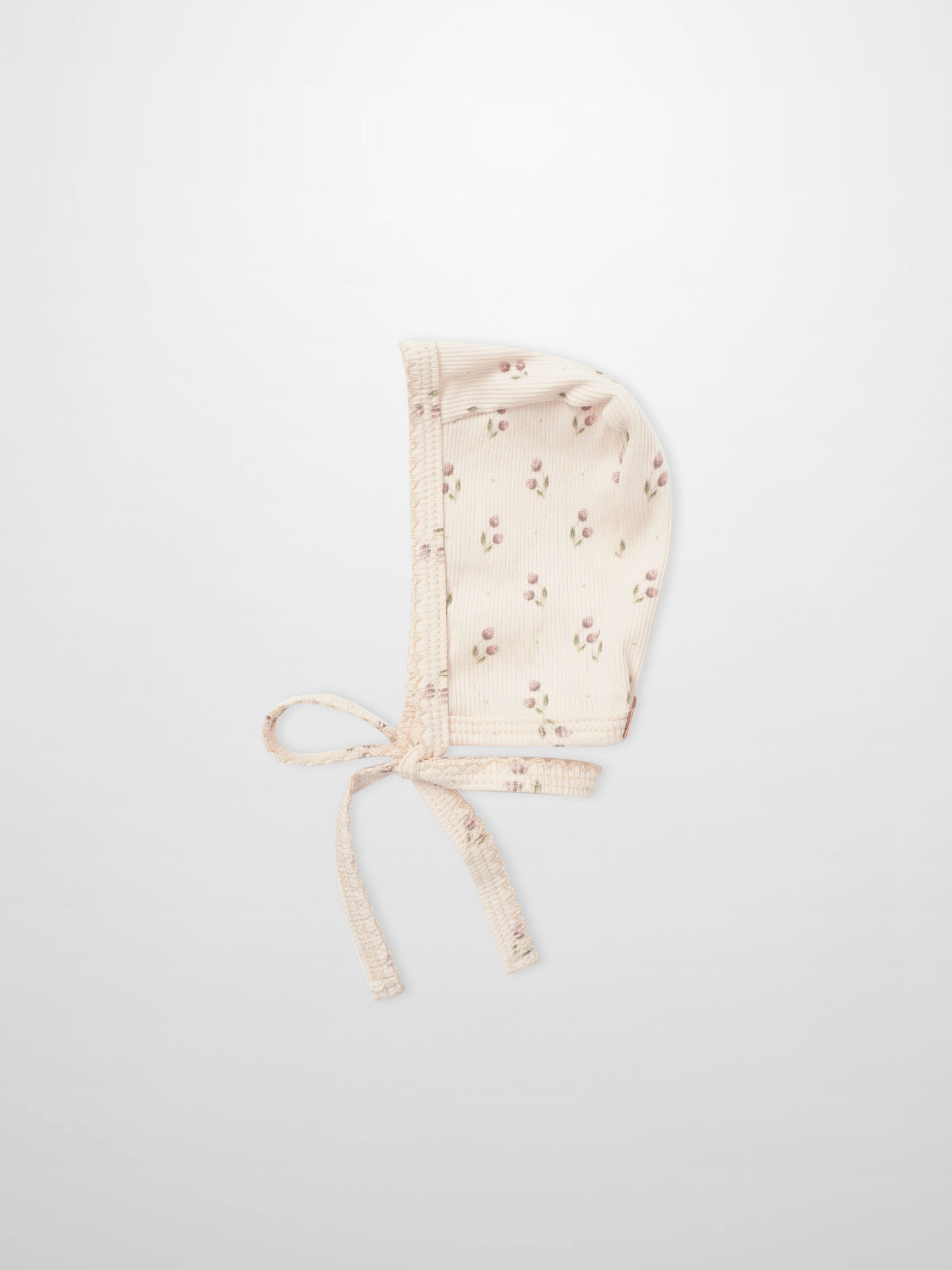 Tiny Tulip Bonnet for girls by Adee; pale pink floral print fabric with tie straps