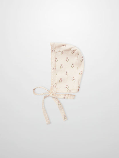 Tiny Tulip Bonnet for girls by Adee; pale pink floral print fabric with tie straps