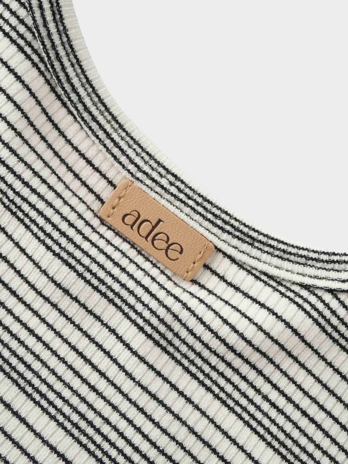 adee label on a black striped kids shirt 