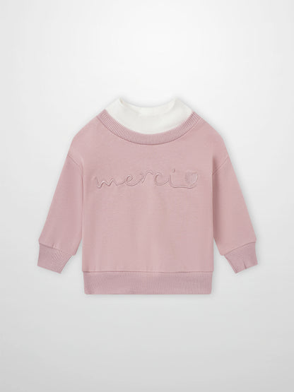 Contrast pink mock-neck sweatshirt for girls by Adee, with white collar and embroidered merci motif.