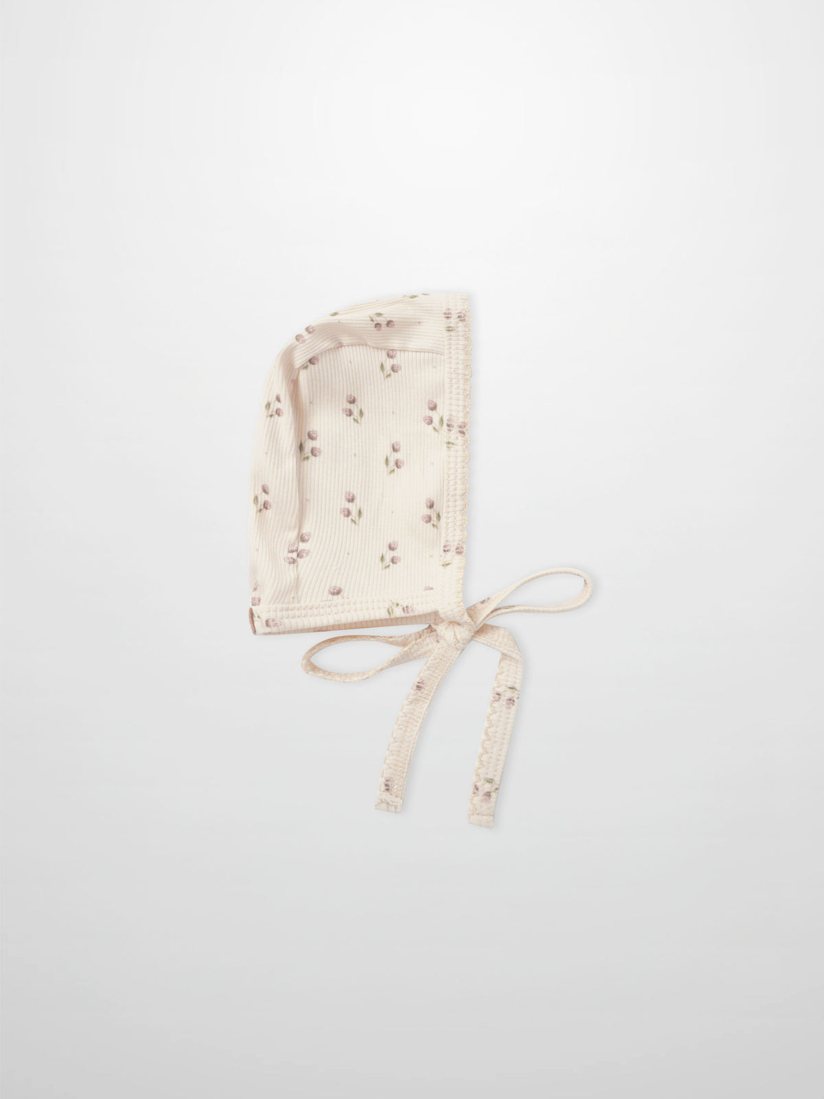 Adee Tiny Tulip layette bonnet in cream ribbed fabric with pink floral print and ties