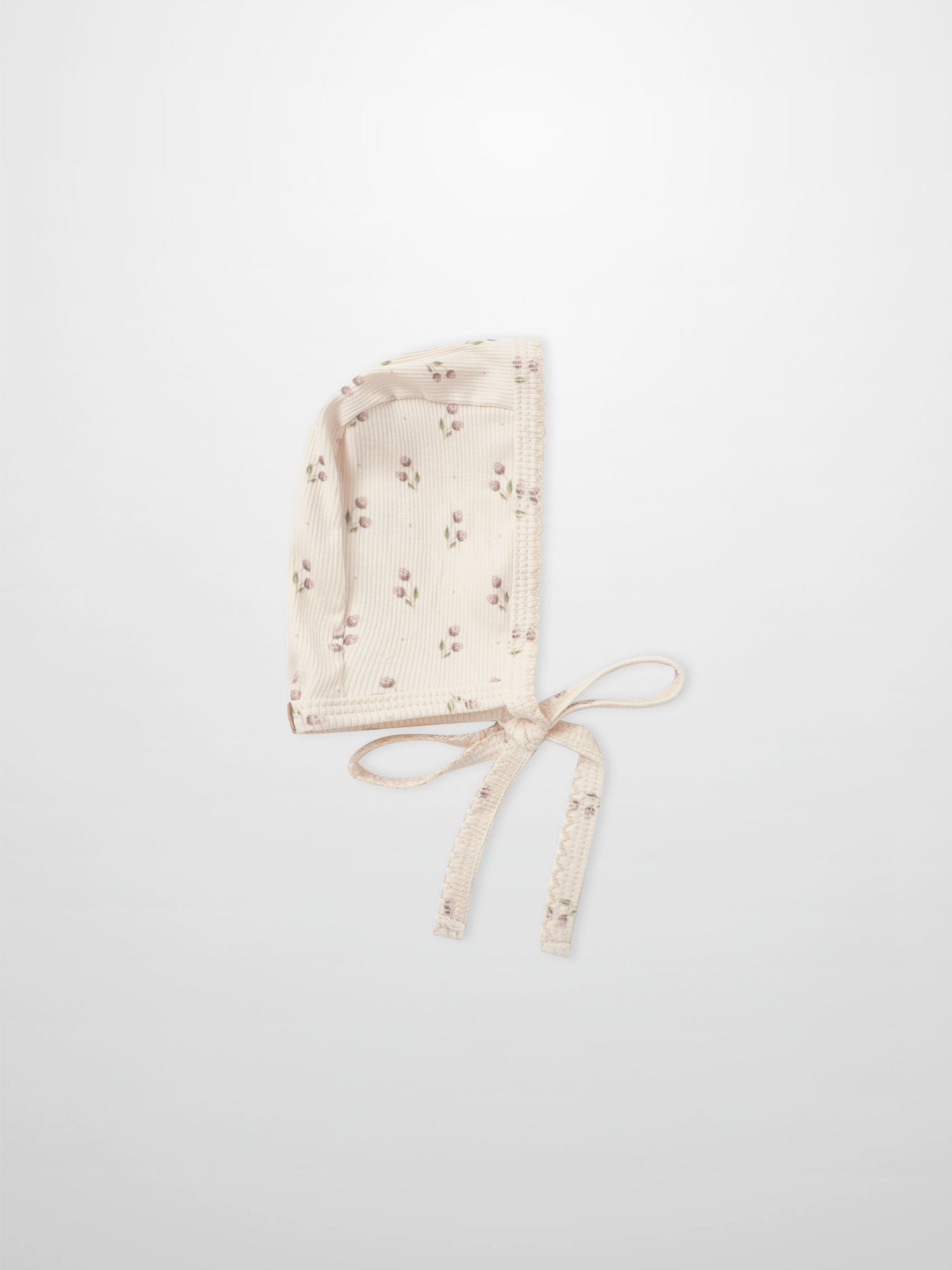 Adee Tiny Tulip layette bonnet in cream ribbed fabric with pink floral print and ties