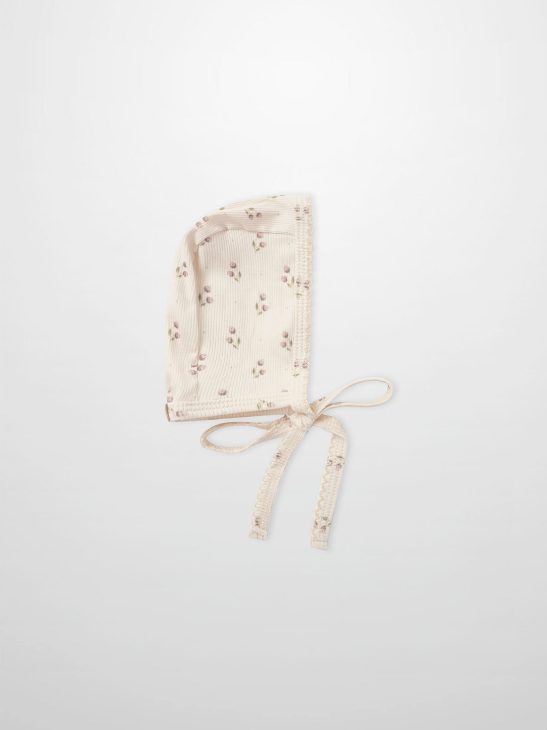 Tiny Tulip Bonnet in cream ribbed fabric with pink floral print and tie strings