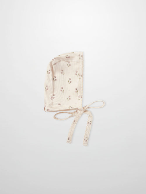 Tiny Tulip Bonnet in cream ribbed fabric with pink floral print and tie strings